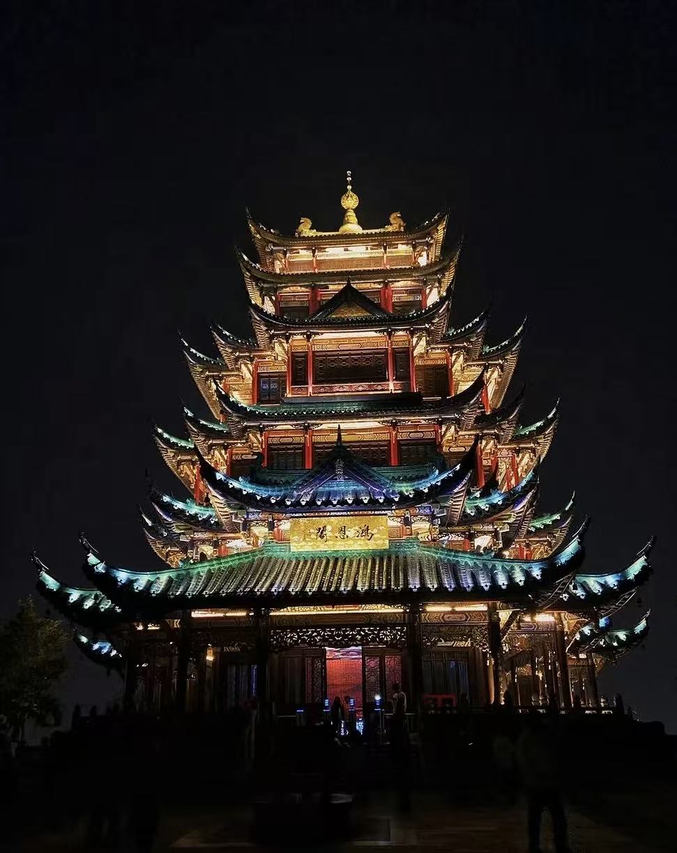 A brightly illuminated pavilion in Chongqing at night