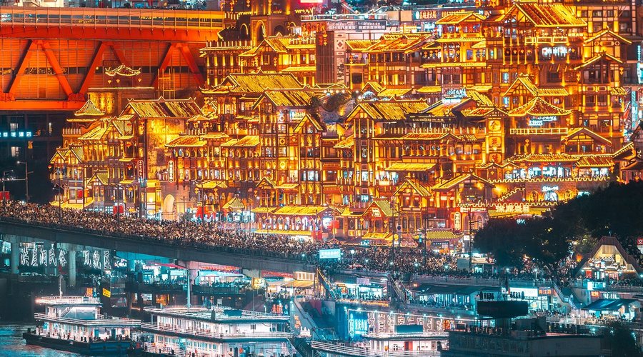 Hongya Cave glowing above the river at night