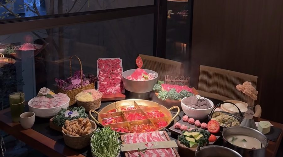 Private Chongqing hotpot table with dishes and glowing broth