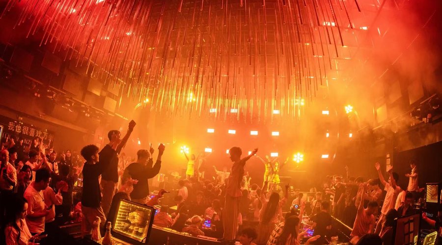 Chongqing nightlife crowd under warm club lights
