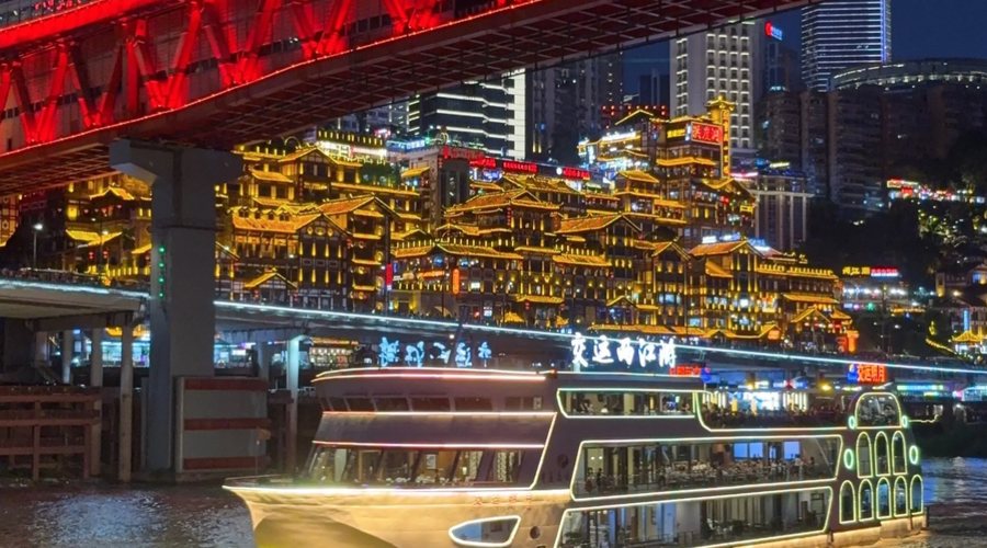 Two Rivers night cruise boat passing Chongqing lights