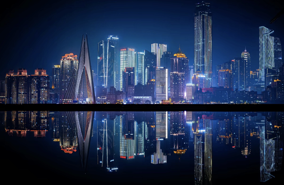 Chongqing skyline glowing above the river at night